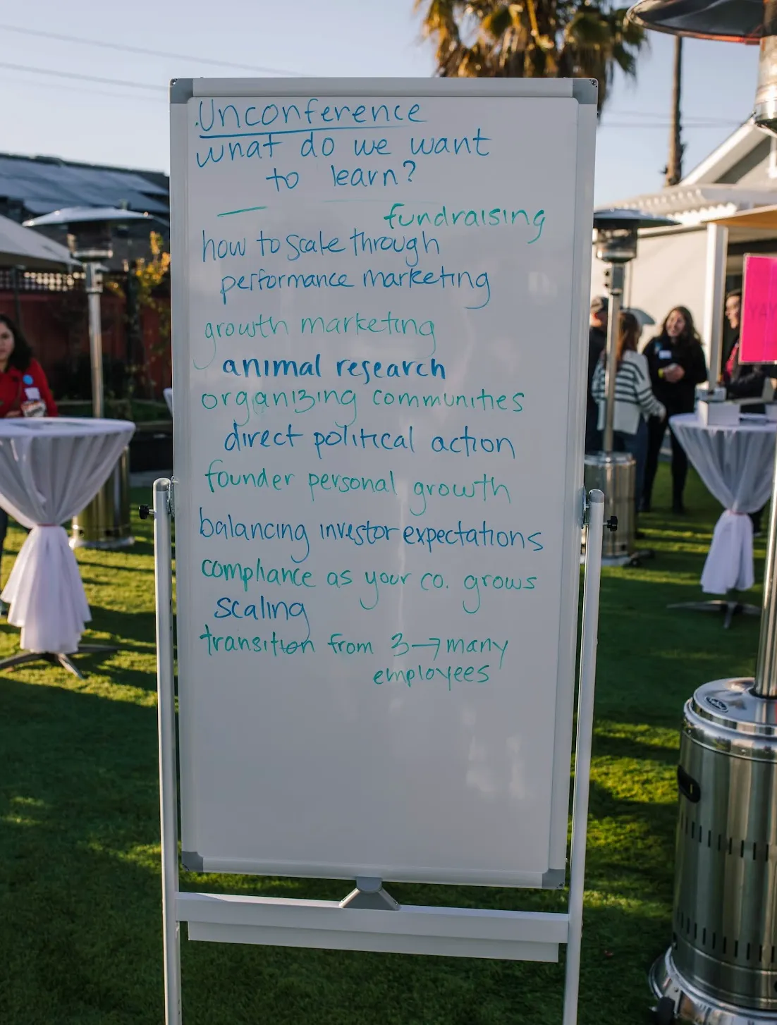 A whiteboard headed 'Unconference: what do we want to learn?' listing founder topics such as fundraising, growth marketing, and scaling.